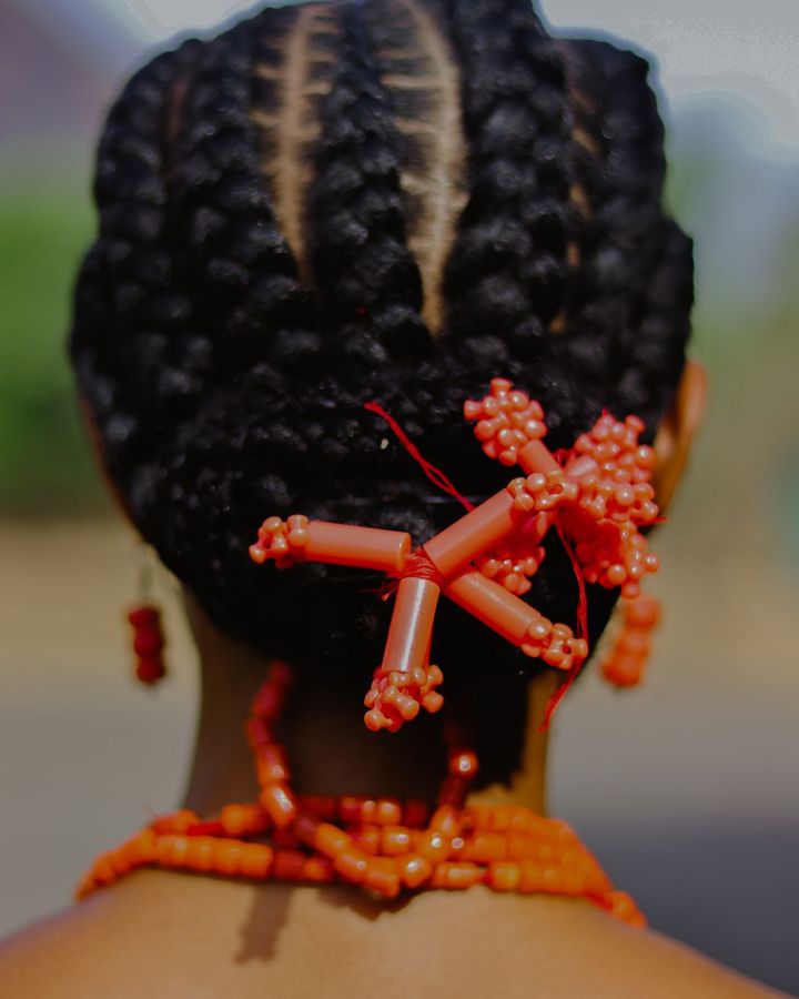 Cornrow updo decorated with coral beads